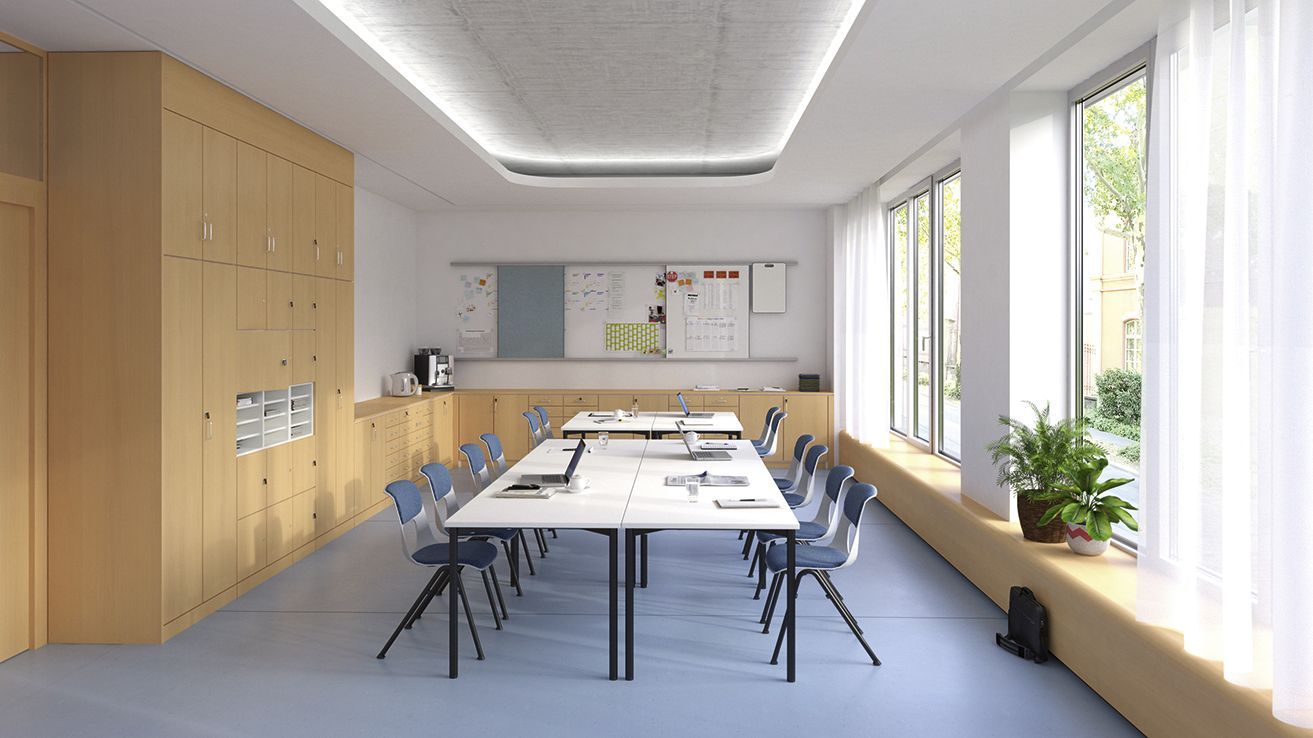 An office for teaching staff with rectangular tables and upholstered NF-Compass chairs by VS