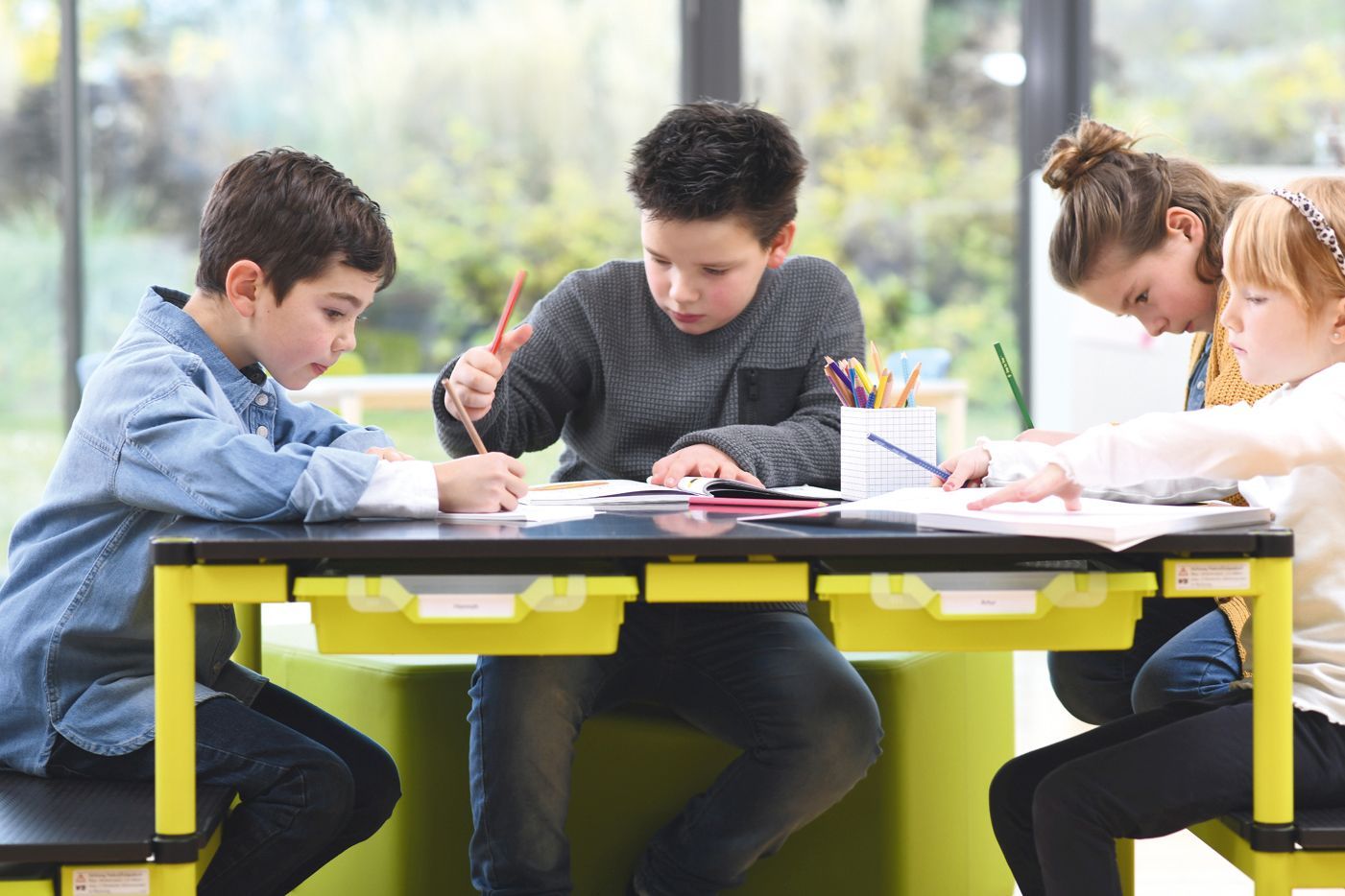 Children are painting sitting on Shift+ Up pedestals, which serve as tables and benches for floor-level playing