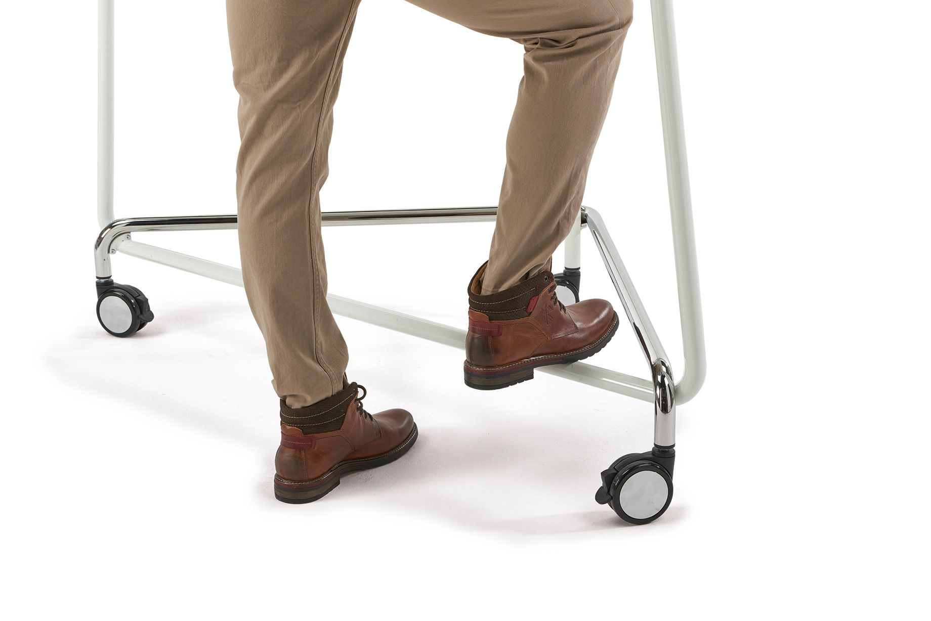 A person places their foot on the footrest of the TriUnion high table by VS