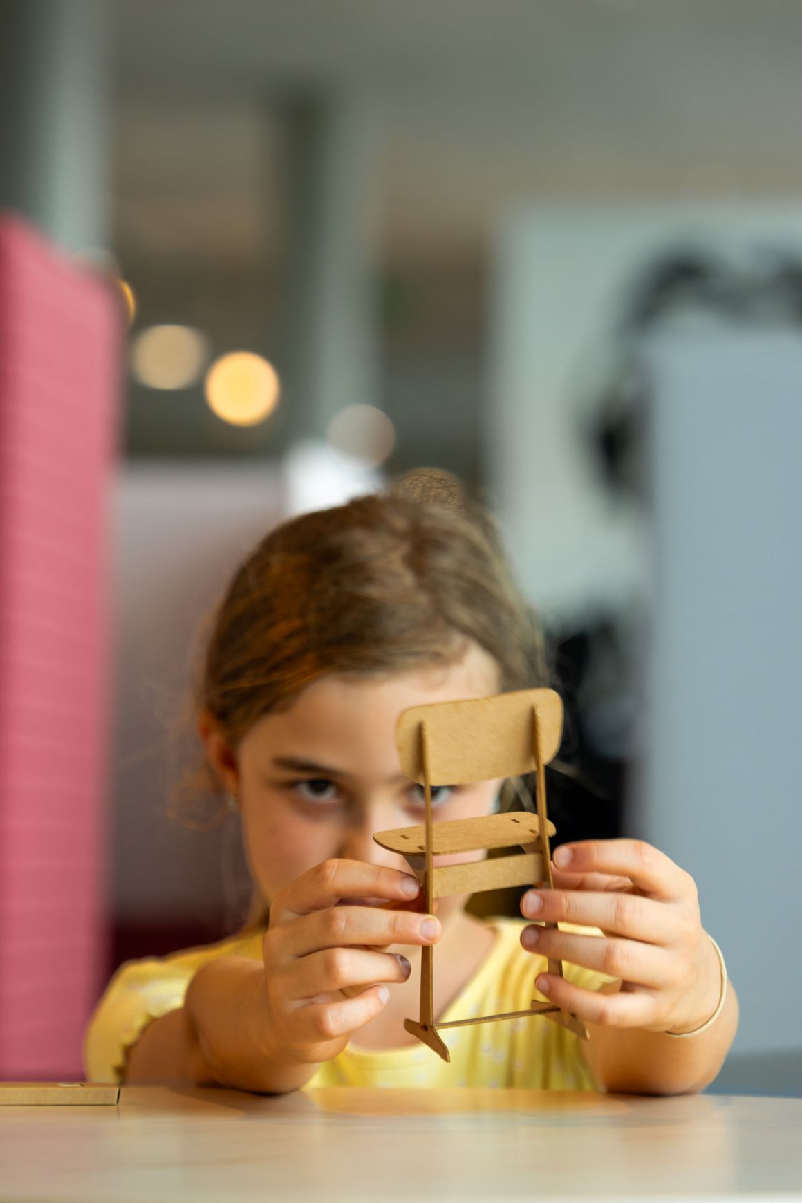 A little girl plays with a mini skid chair from VS.