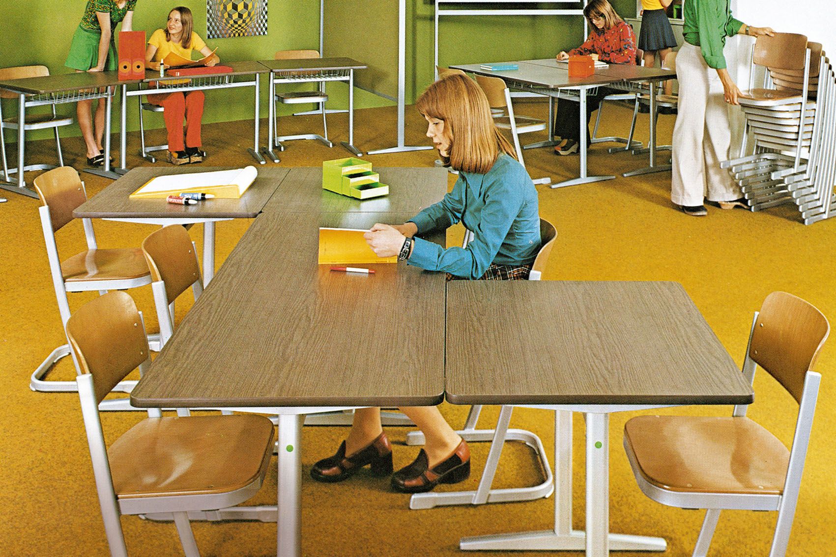 A girl learns in a classroom with skid chairs and tables by VS