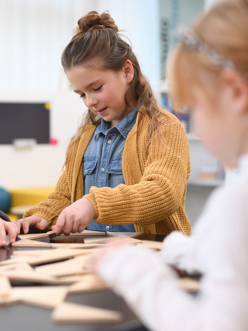 A child puts a model together to learn through play.