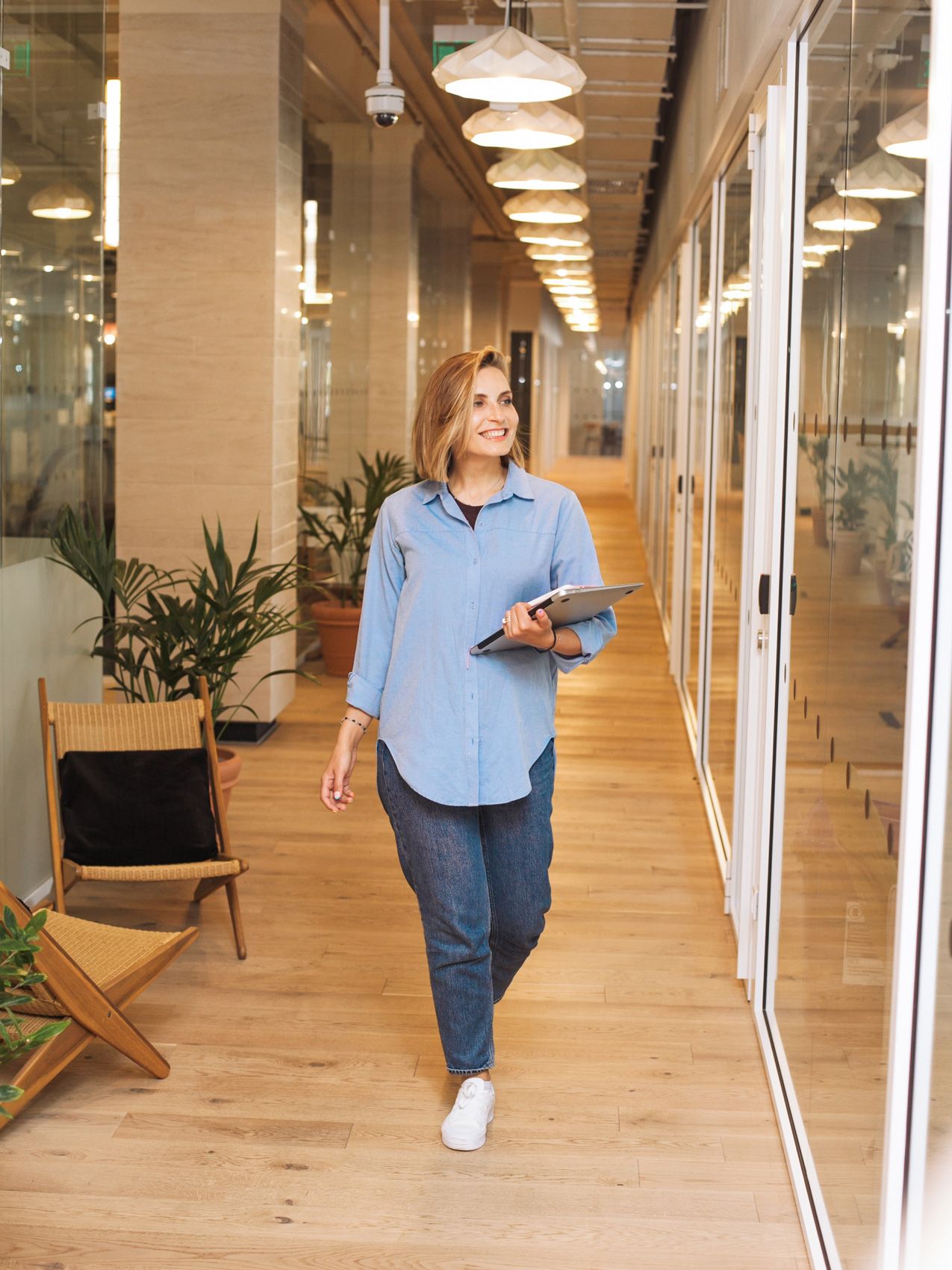 A woman walks in the corridor of an office