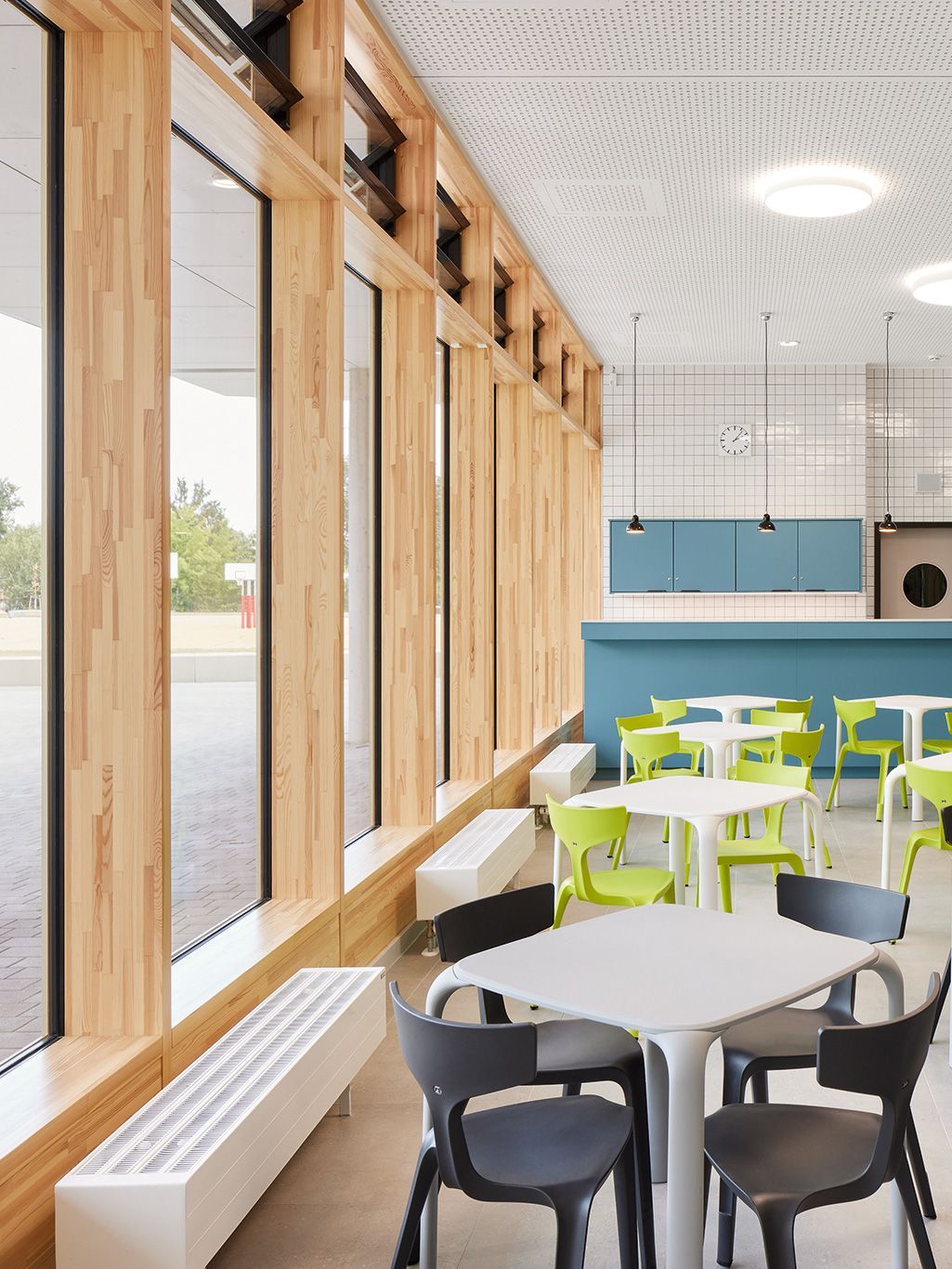 A cafeteria with Stakki stackable chairs and DROP stackable tables by VS.