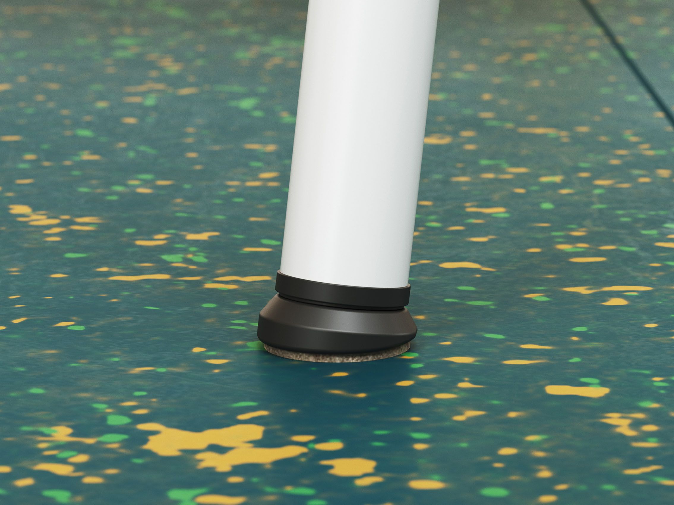 Close-up of a chair leg with glides on elastic flooring