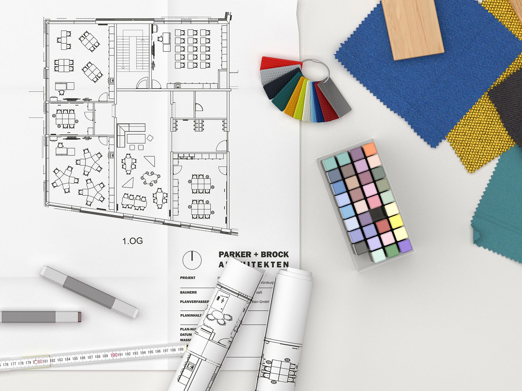 A floor plan lies on a table next to colour and material samples