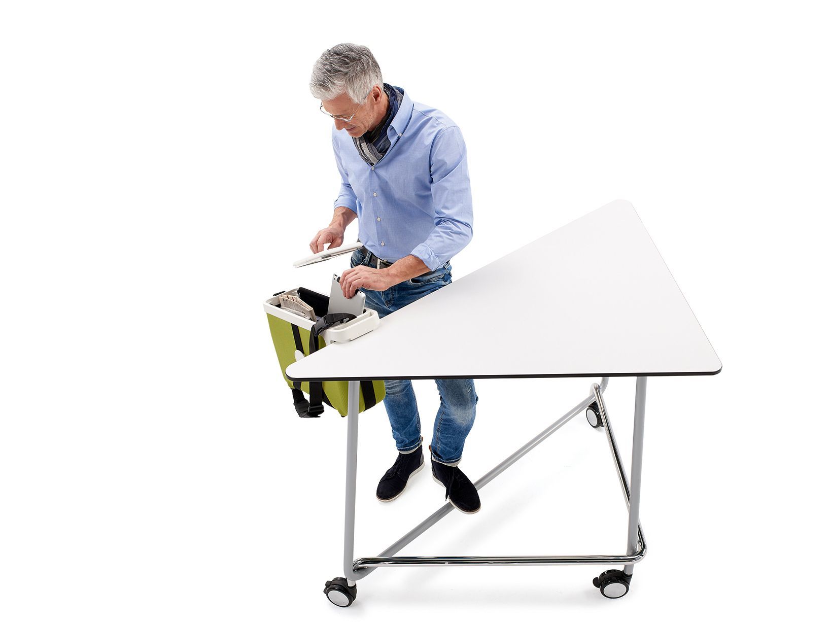 A man takes a tablet out of the eddy bag hanging on the TriUnion high table