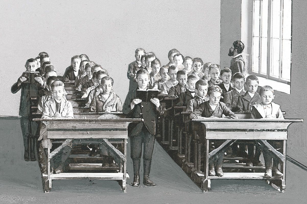 Black and white image of a classroom around 1900 with Rettig benches