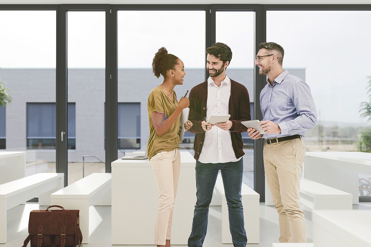 Three people are engaged in a conversation