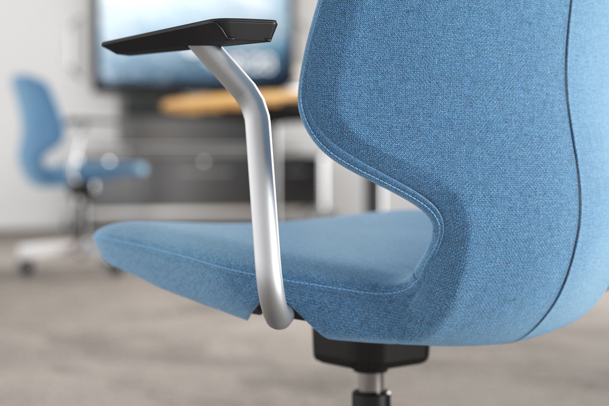 JUMPER Move chair with armrests and light blue fabric cover in an office setting