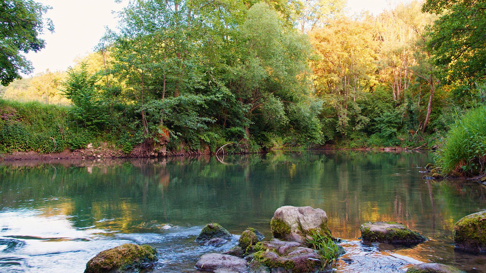 Water flows around stones in the Tauber