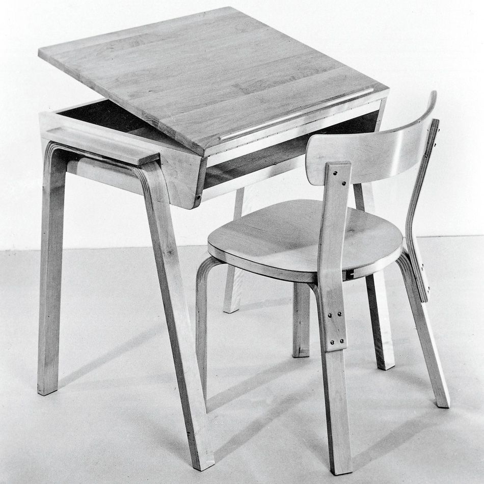 Black and white image of a wooden chair and a table with a tilting top, designed by Finnish architect and furniture designer Alvar Aalto in the 1930s to 1950s