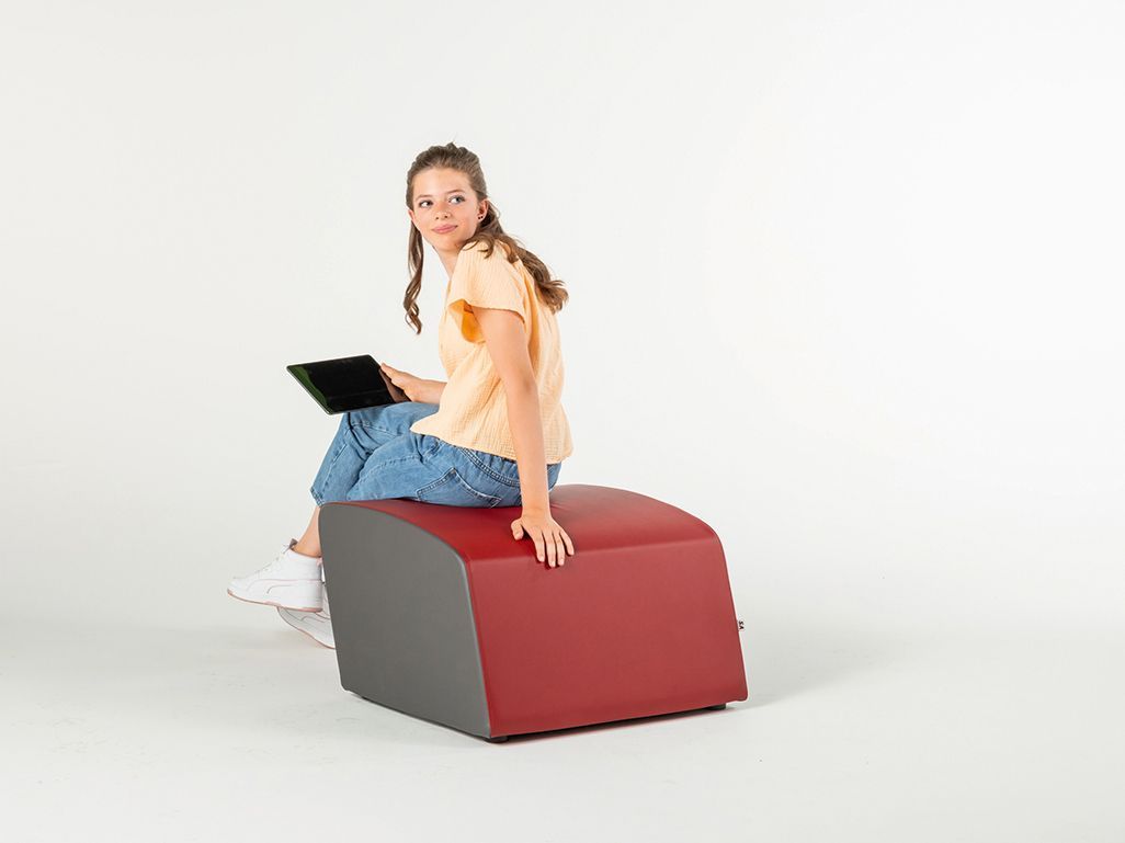 Young woman sitting with a tablet on a red stool from the ClubLounge series by VS.