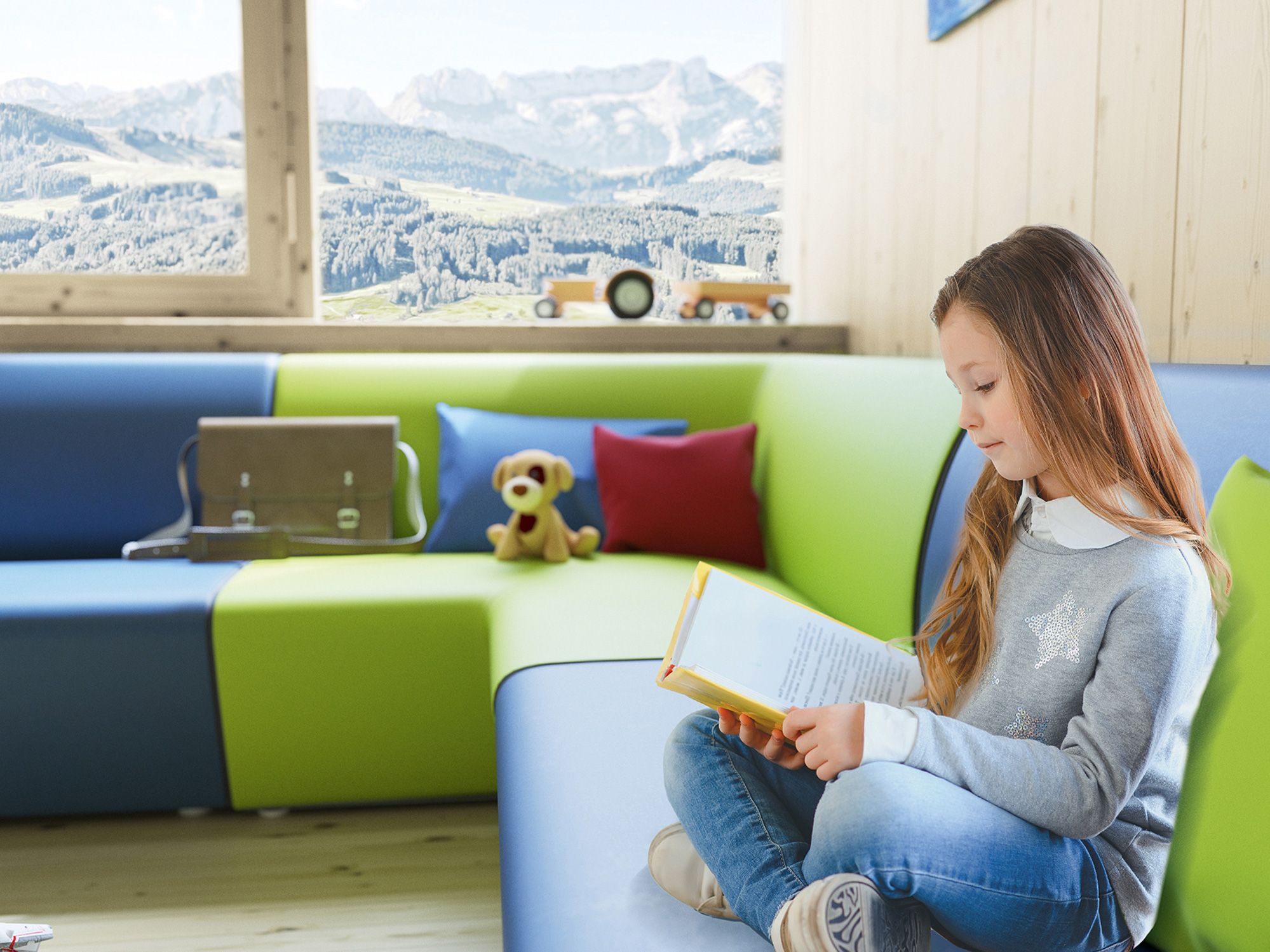 A young girl reads a book on the couch ClubLounge by VS.