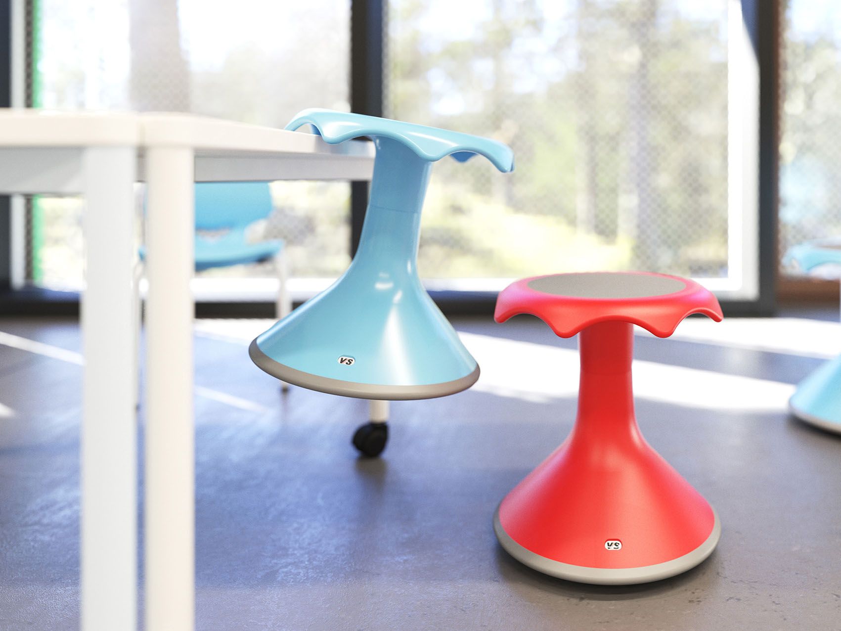 A light blue Hokki suspended on a table, next to a red Hokki on the floor