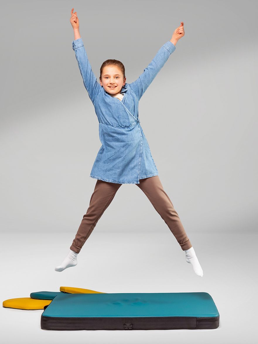 A girl jumps on a padded mat from the FloorFriends series by VS