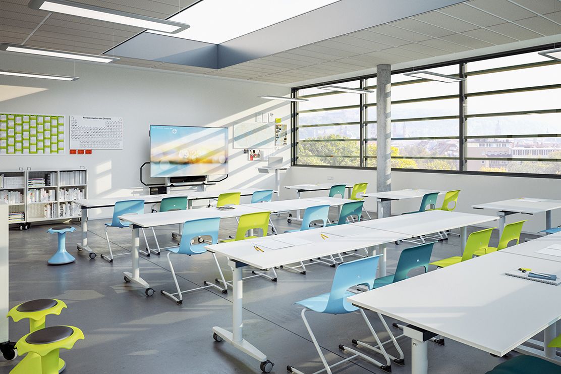 A classroom setup with tables and chairs, providing a conducive space for teaching and learning interactions.